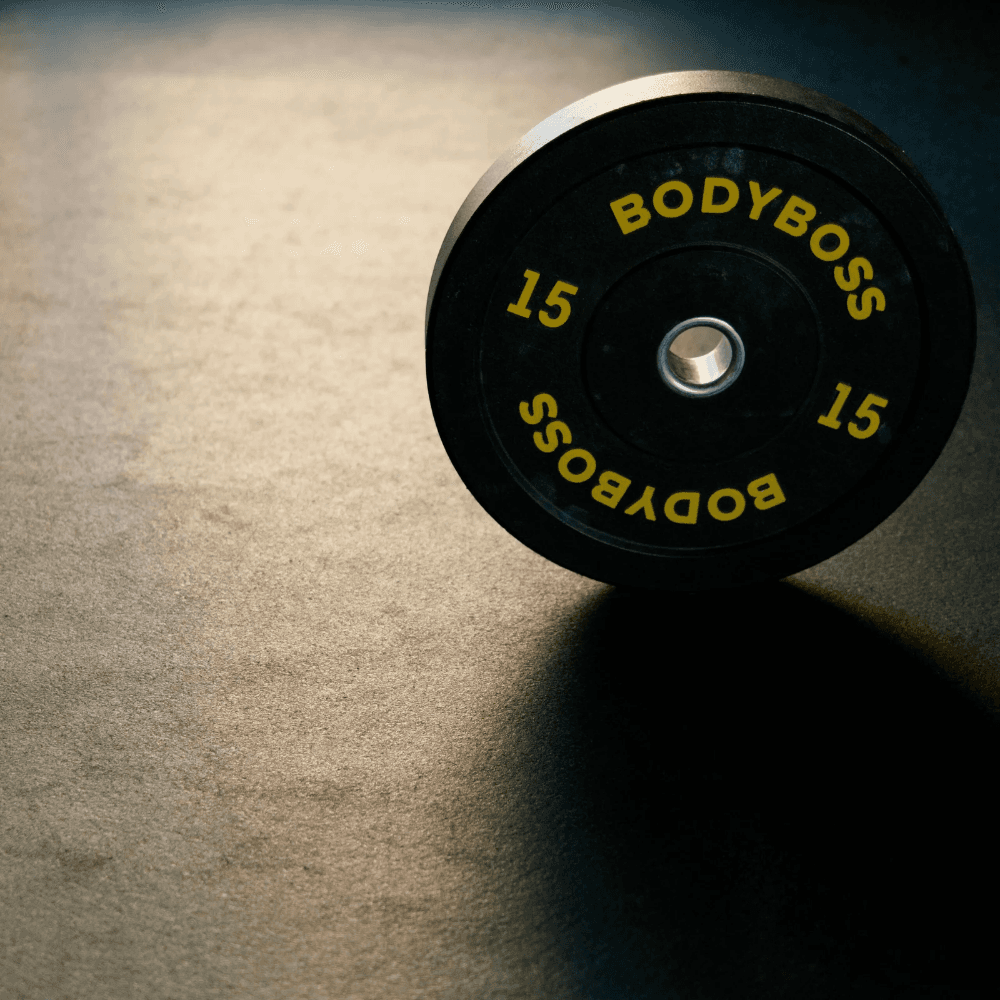 Weight plate resting on a matte rubber gym floor