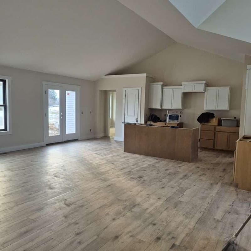Wide-plank flooring in a vaulted-ceiling great room and kitchen