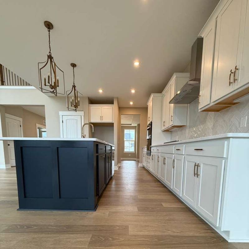 Long galley kitchen with freshly installed plank flooring