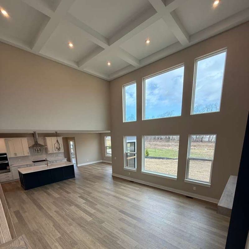 Great room with tall windows and new hardwood-look flooring
