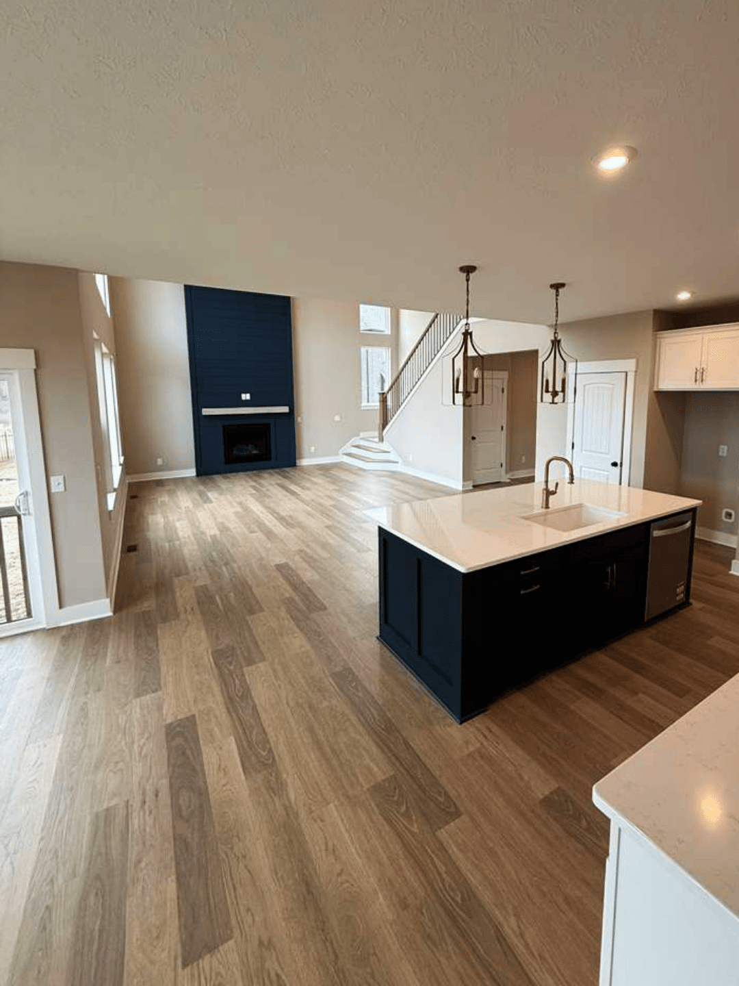 Open-concept great room and kitchen finished in wide-plank luxury vinyl